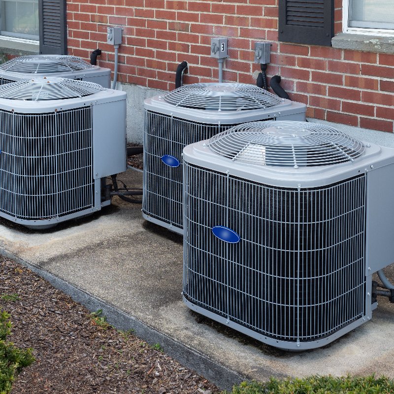 row of modern AC units sitting outside a building 