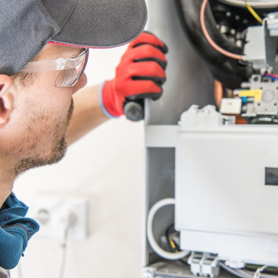 A man inspecting a heater.