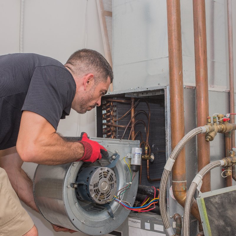 technician removing a blower in an air conditioner