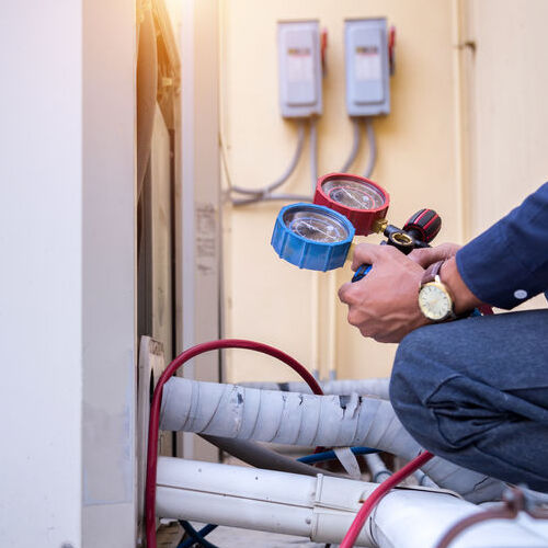 A Technician Checks an Air Conditioner.