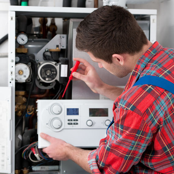 An HVAC tech testing a heater.