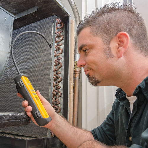 An HVAC Technician Test AC Coils.