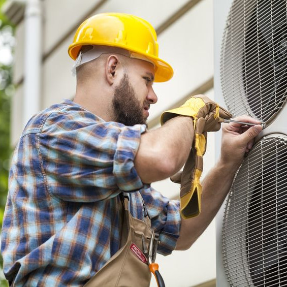 An HVAC tech working outside.